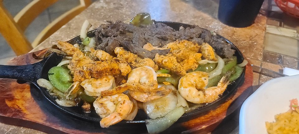 Shared plates on a lively restaurant table.