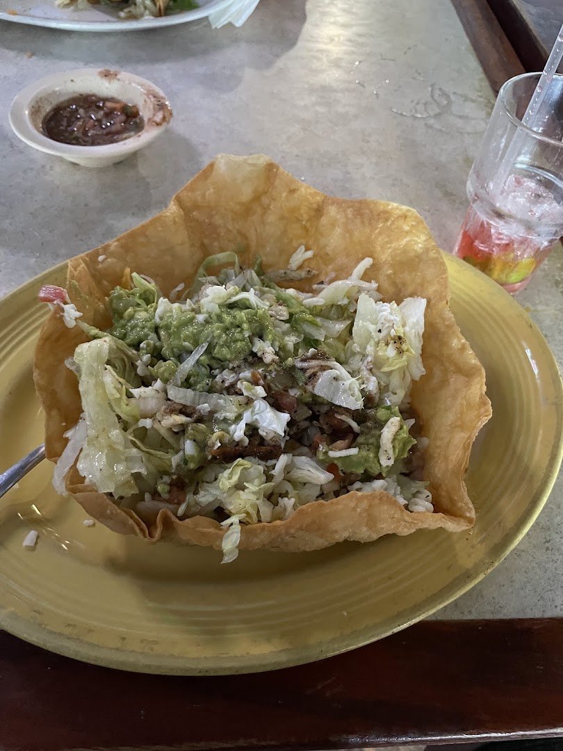Shared plates on a lively restaurant table.
