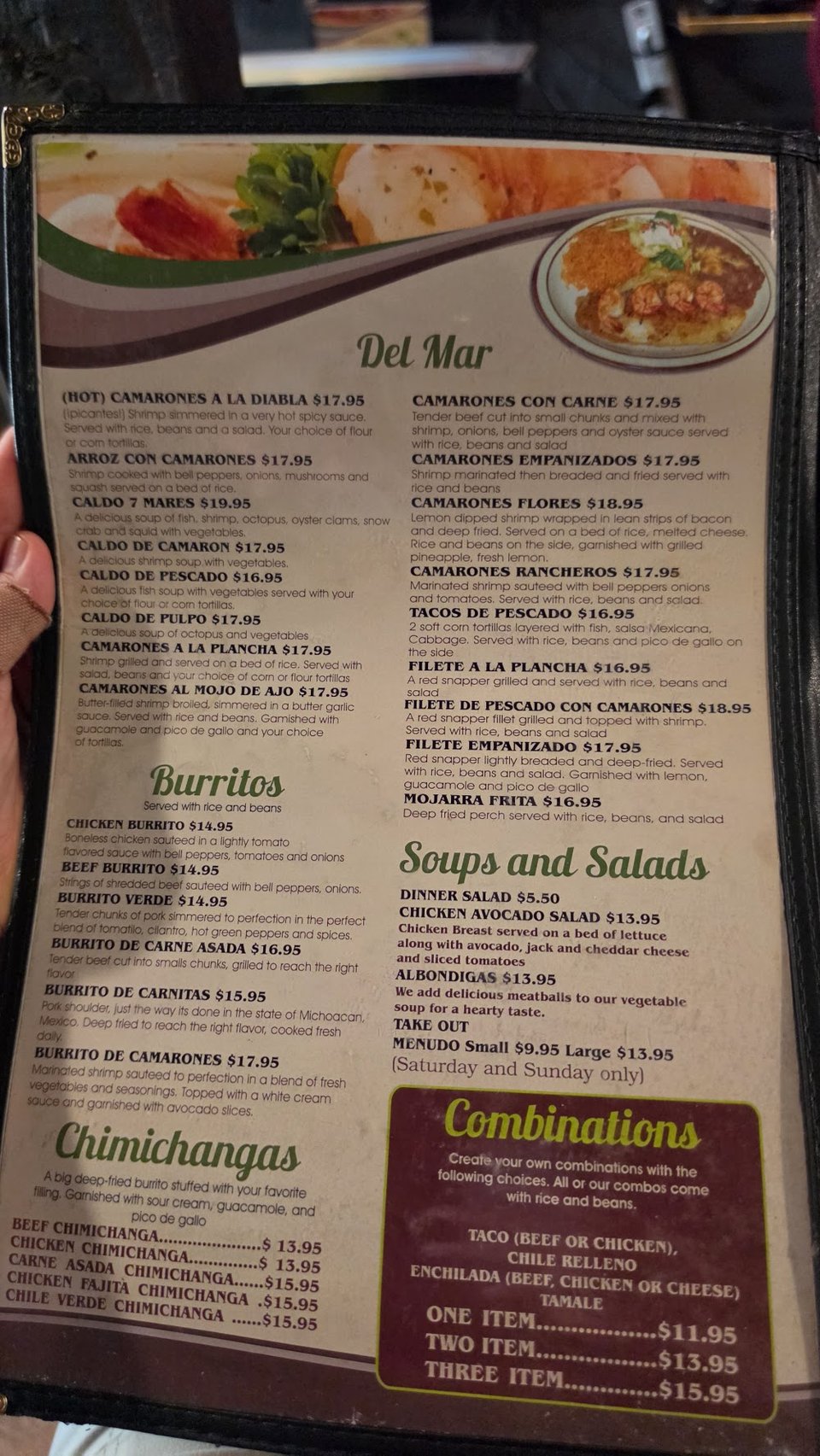 Close-up of a restaurant menu with dish names.